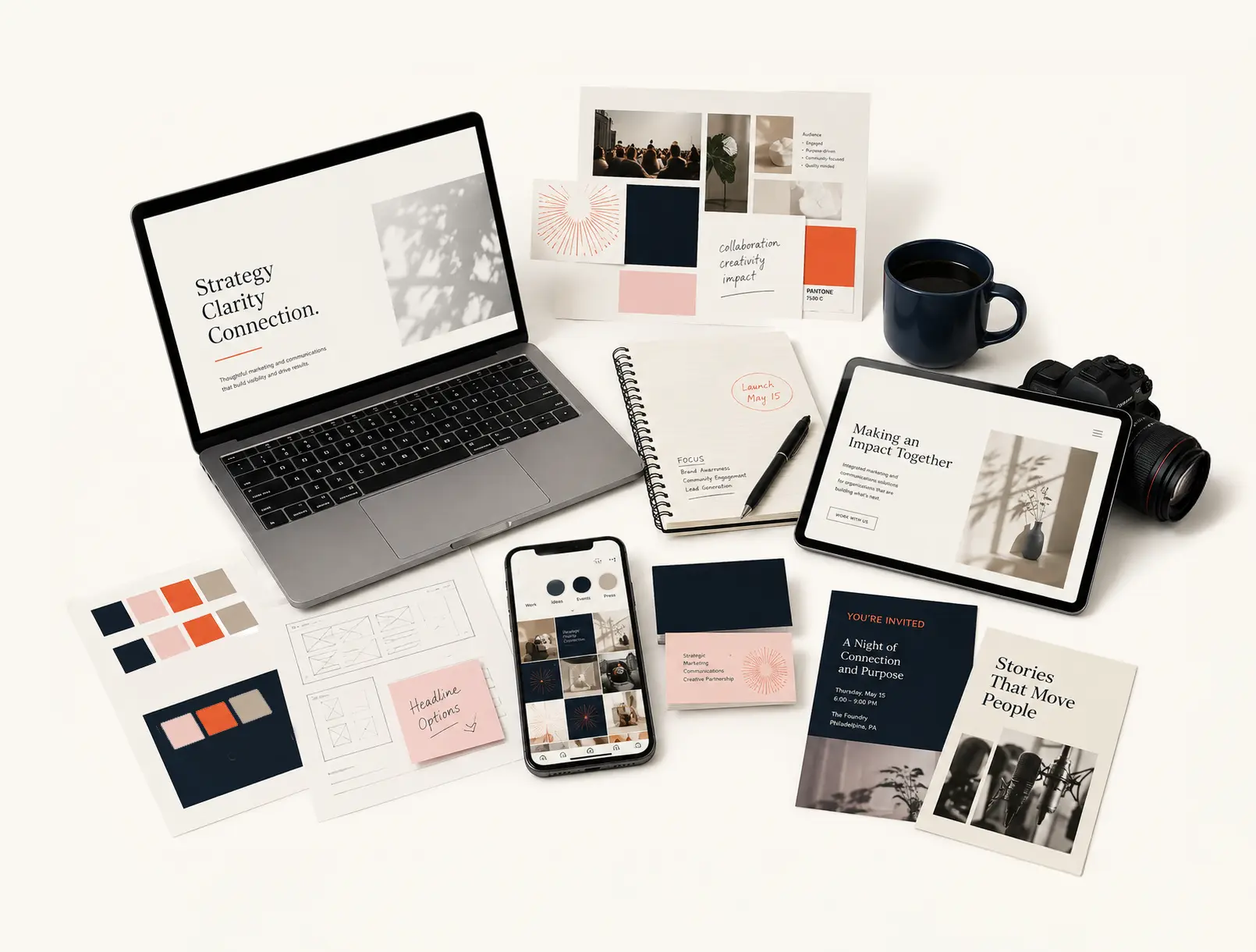 Items on a desk including a laptop, notes, mockups, and other client projects